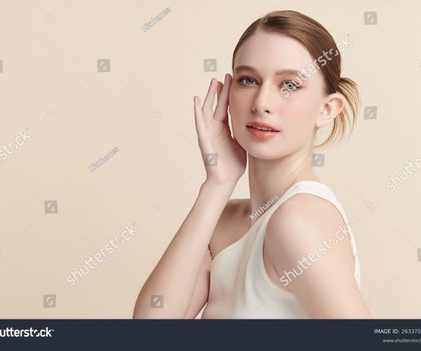 stock-photo-a-beautiful-young-woman-with-clean-fresh-skin-against-a-beige-background-skincare-facial-2633703589