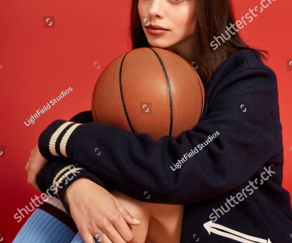 stock-photo-young-woman-showcases-bold-fashion-while-sitting-with-a-basketball-exuding-confidence-and-style-2652149253
