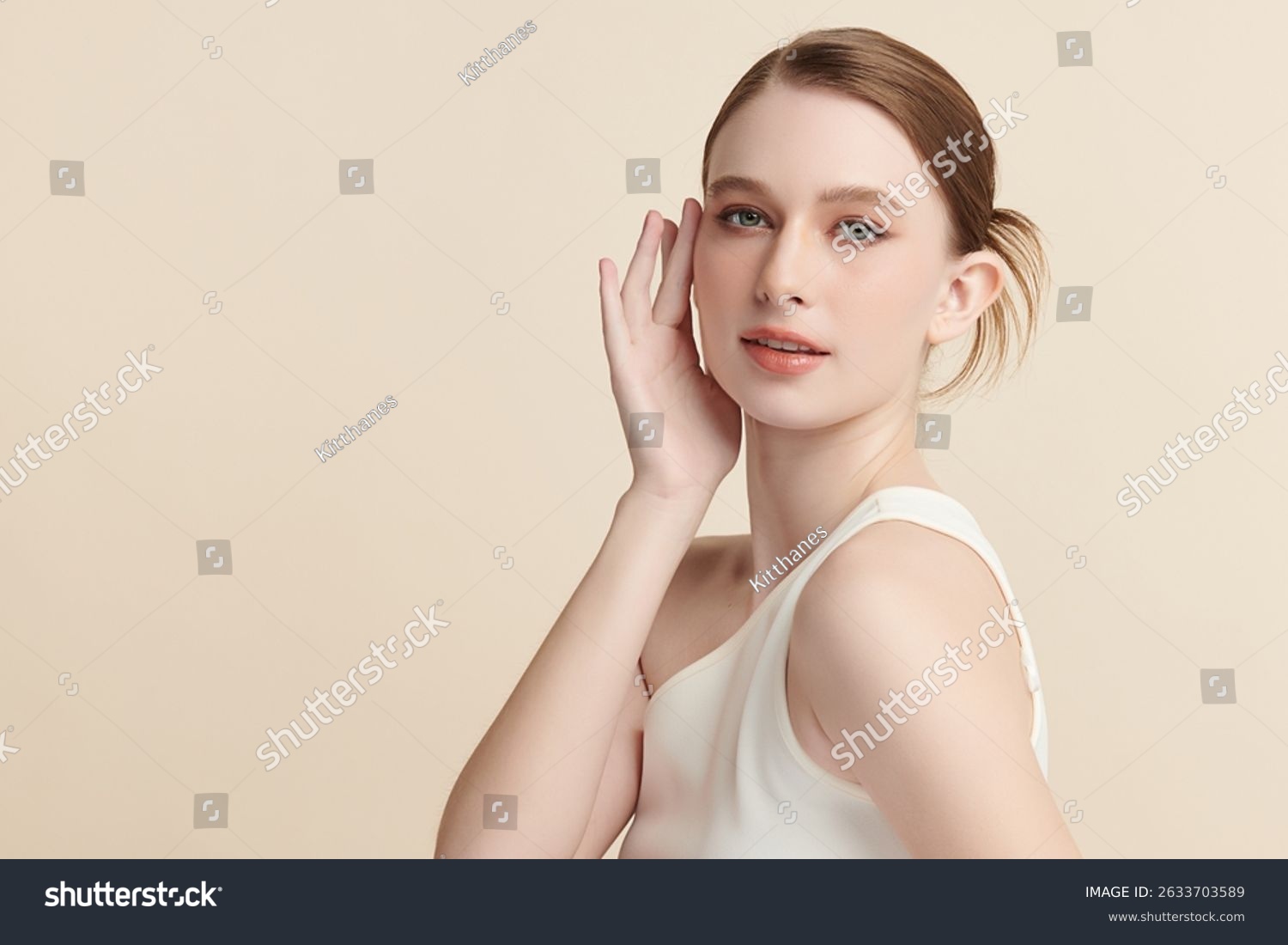 stock-photo-a-beautiful-young-woman-with-clean-fresh-skin-against-a-beige-background-skincare-facial-2633703589