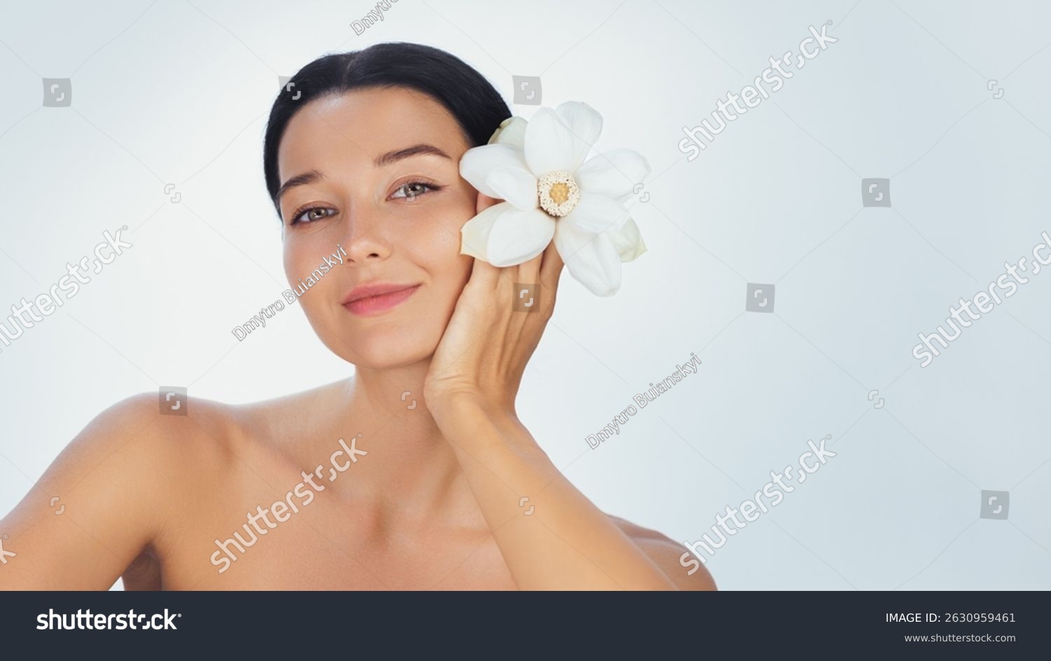 stock-photo-a-serene-young-woman-holds-a-white-flower-by-her-face-symbolizing-purity-and-elegance-her-smooth-2630959461