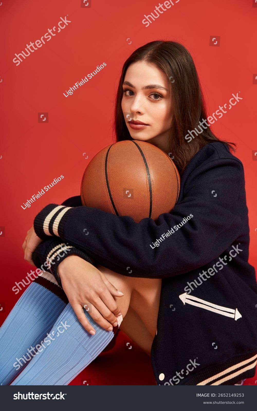 stock-photo-young-woman-showcases-bold-fashion-while-sitting-with-a-basketball-exuding-confidence-and-style-2652149253